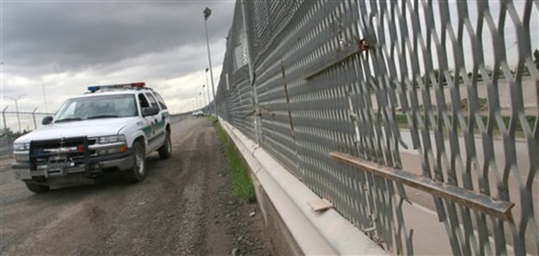 A Border Patrol vehicle drives past a portion of the border fence in El Paso, Texas, in 2007. The Obama administration on Friday ended a high-tech southern border fence plan that cost taxpayers nearly $1 billion. 